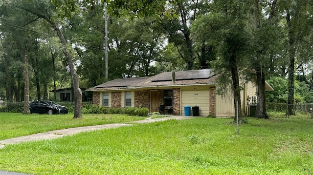 single story home featuring a front lawn, solar panels, and central AC