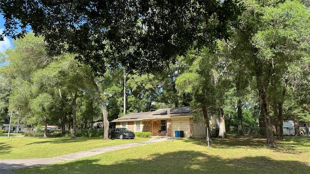 view of front facade with a front lawn and solar panels