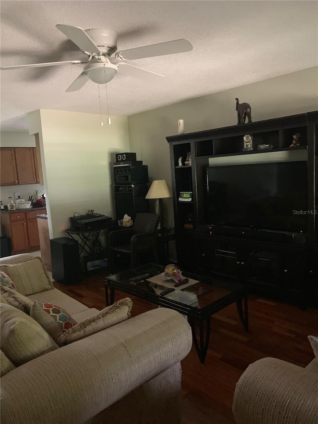 living room with ceiling fan and dark hardwood / wood-style floors