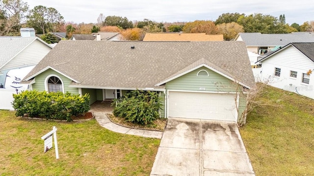 view of front of house featuring a front lawn and a garage