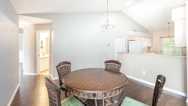 dining space featuring vaulted ceiling, dark hardwood / wood-style floors, and a chandelier