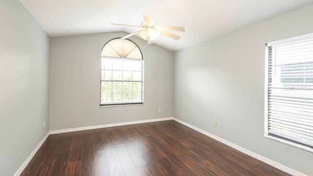 spare room featuring vaulted ceiling, ceiling fan, a textured ceiling, and dark hardwood / wood-style floors