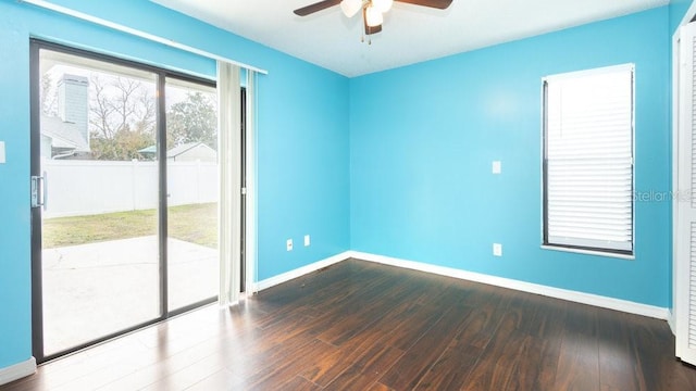 unfurnished room featuring ceiling fan and dark wood-type flooring