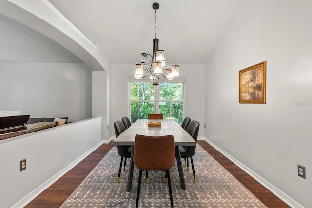 dining area featuring dark hardwood / wood-style flooring and a chandelier