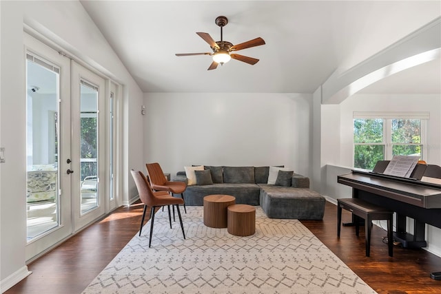 living room with ceiling fan, french doors, dark hardwood / wood-style floors, and vaulted ceiling