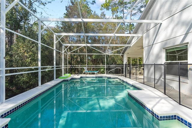 view of swimming pool featuring a lanai and a patio area