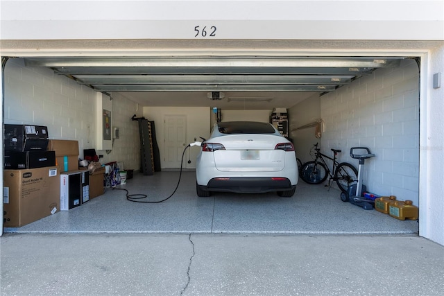 garage with electric panel and a garage door opener