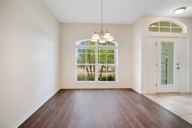 entrance foyer with dark wood-type flooring and a chandelier