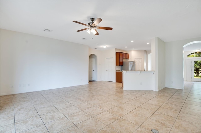 unfurnished living room with ceiling fan and light tile patterned floors