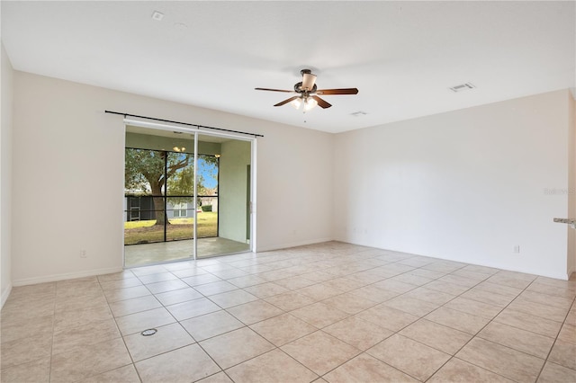 tiled spare room featuring ceiling fan