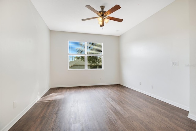 spare room featuring dark wood-type flooring and ceiling fan