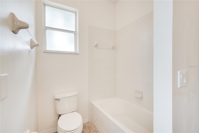 bathroom with tub / shower combination and toilet