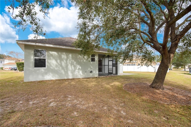 back of property featuring a lawn