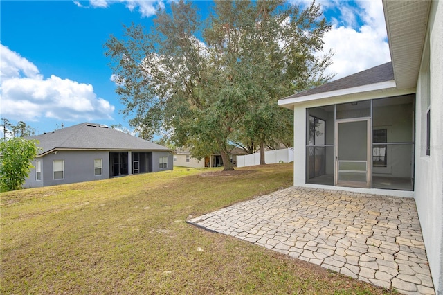 view of yard with a sunroom and a patio