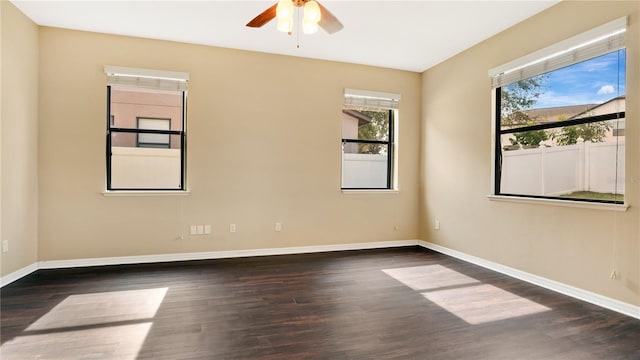 spare room featuring ceiling fan and dark wood-type flooring