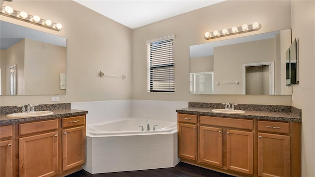 bathroom featuring separate shower and tub, hardwood / wood-style flooring, and vanity