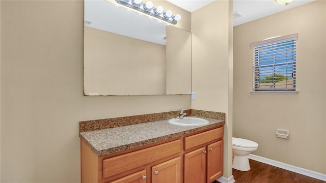 bathroom featuring hardwood / wood-style floors, toilet, and vanity