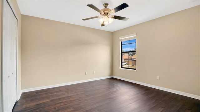 spare room with ceiling fan and dark wood-type flooring