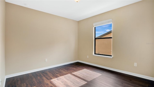 spare room featuring dark hardwood / wood-style floors