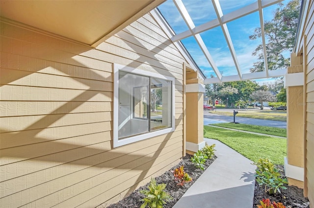 view of side of property with a pergola and a lawn