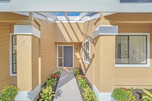 entrance to property with a pergola