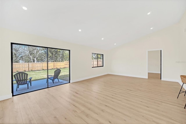 unfurnished living room featuring high vaulted ceiling and light hardwood / wood-style flooring