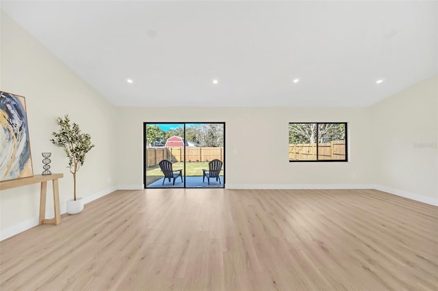 unfurnished living room featuring a healthy amount of sunlight and light hardwood / wood-style flooring