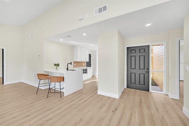 entryway with light hardwood / wood-style floors