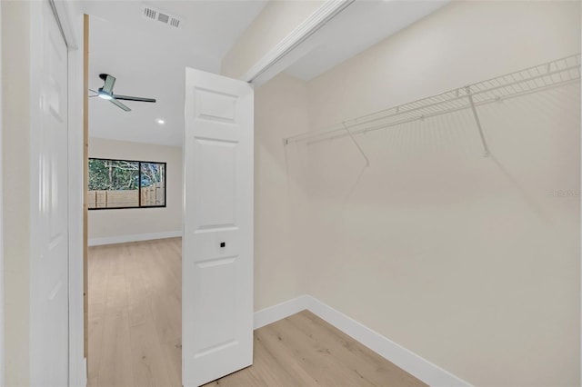 spacious closet featuring hardwood / wood-style floors and ceiling fan