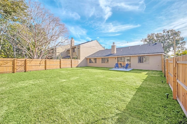 back of house featuring a yard and a patio