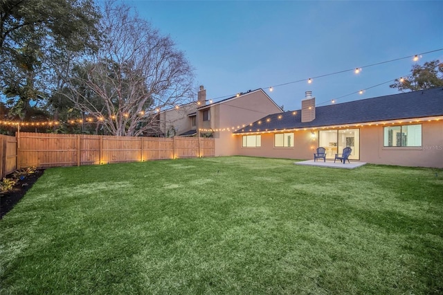 yard at dusk with a patio