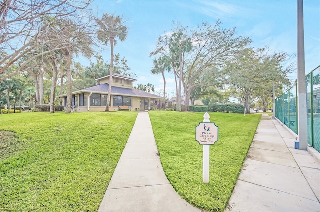 view of home's community with a lawn