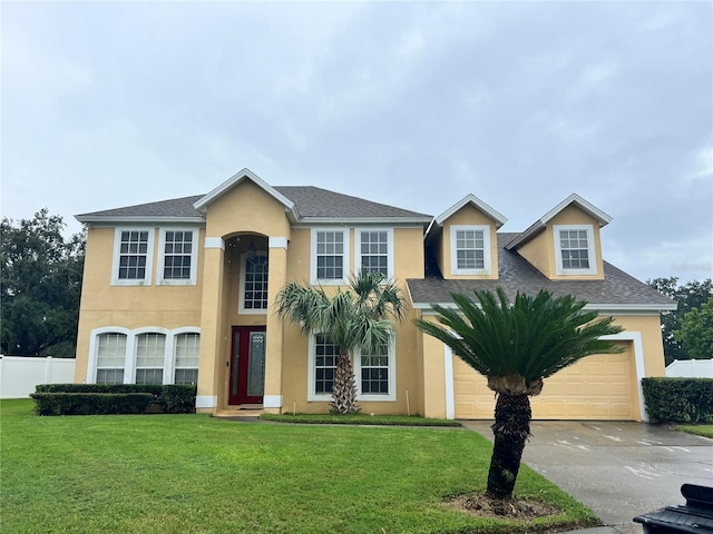 view of front of house with a garage and a front lawn