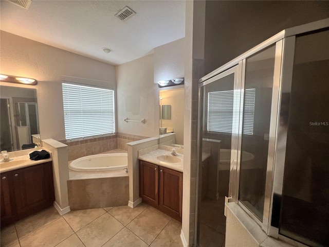 bathroom featuring vanity, tile patterned floors, and shower with separate bathtub