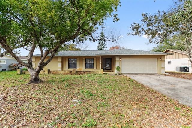 ranch-style home with a garage and cooling unit