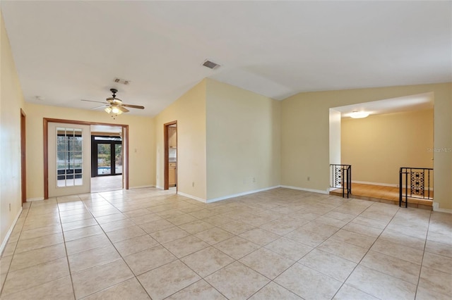 unfurnished room featuring ceiling fan, light tile patterned floors, vaulted ceiling, and french doors