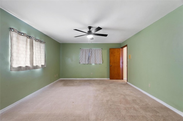 spare room featuring ceiling fan and light colored carpet