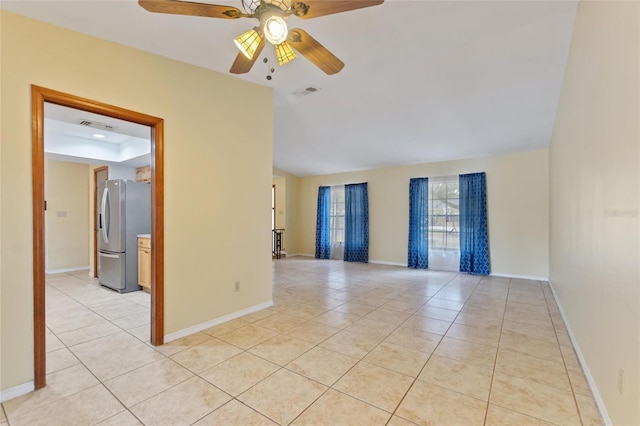 tiled spare room with ceiling fan