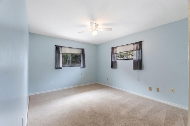 empty room featuring light carpet and ceiling fan