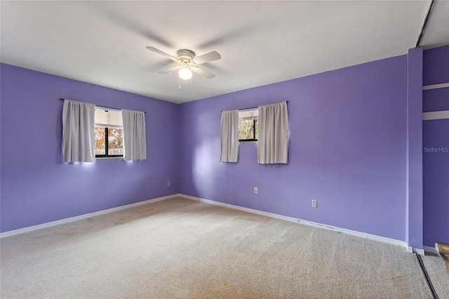 carpeted empty room with ceiling fan