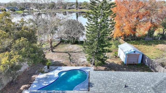 view of pool with a patio area and a water view