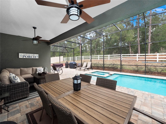 view of swimming pool with an in ground hot tub, a lanai, an outdoor living space, and a patio