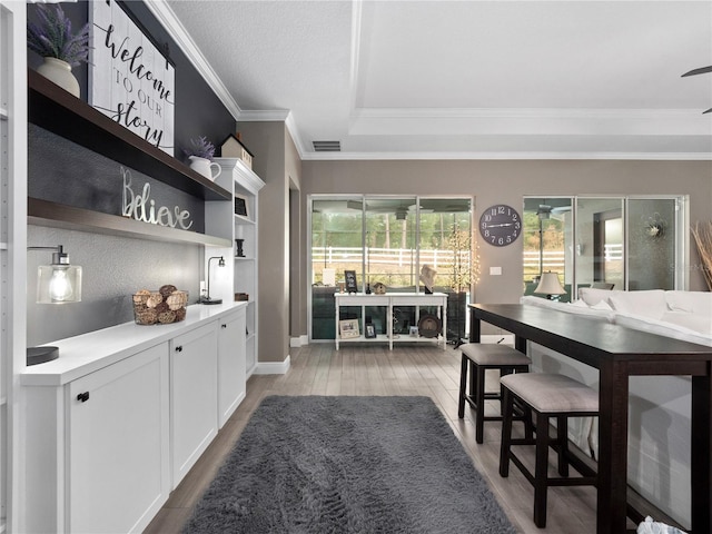 interior space featuring light wood-type flooring and ornamental molding