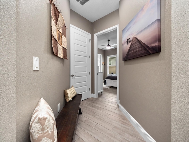 hall with light hardwood / wood-style floors