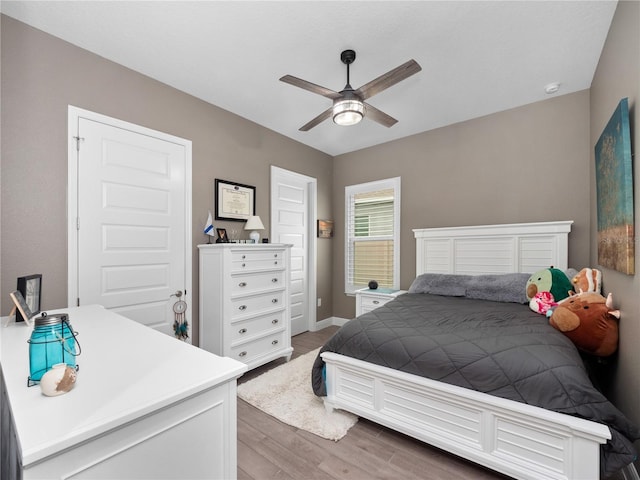 bedroom with ceiling fan and hardwood / wood-style flooring