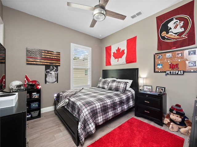 bedroom with light wood-type flooring and ceiling fan