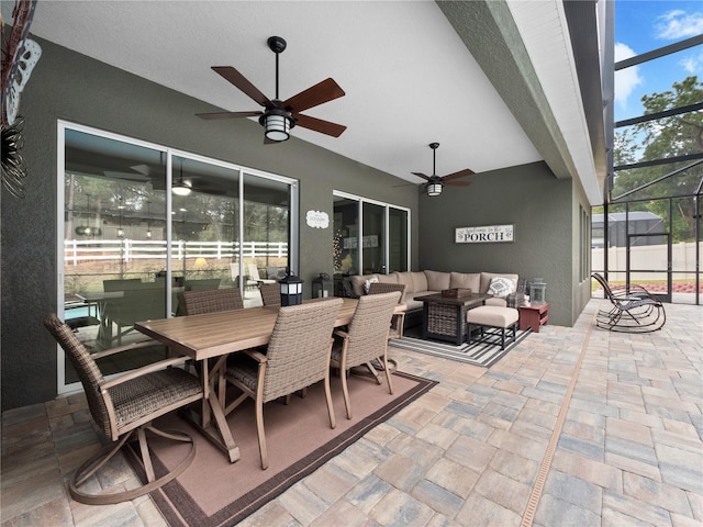 view of patio with ceiling fan, a lanai, and an outdoor hangout area