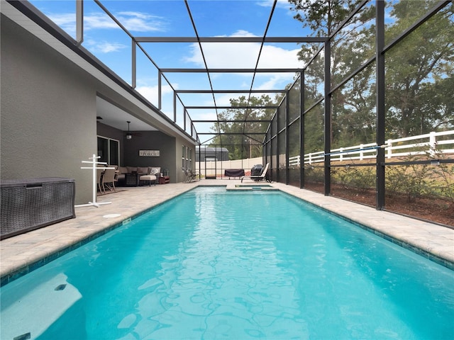 view of pool featuring ceiling fan, a lanai, an outdoor hangout area, and a patio