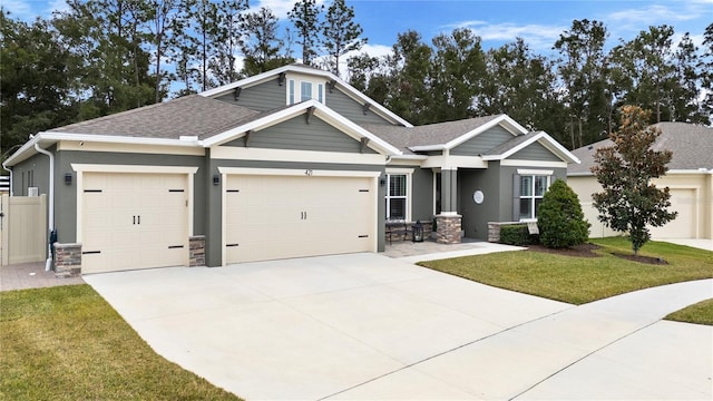 craftsman-style home with a front lawn and a garage