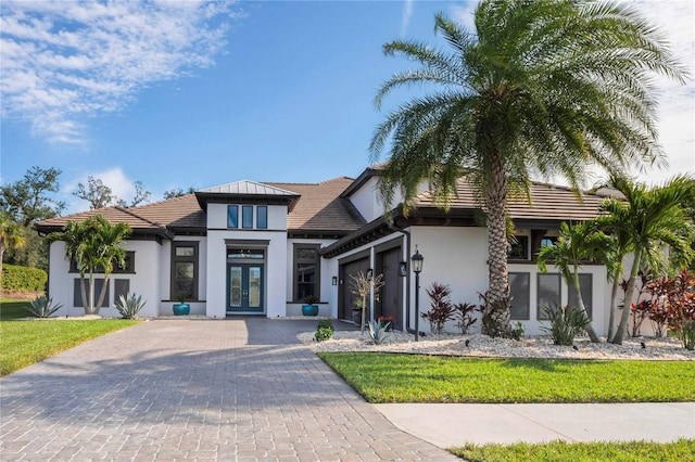 view of front facade featuring a garage and french doors